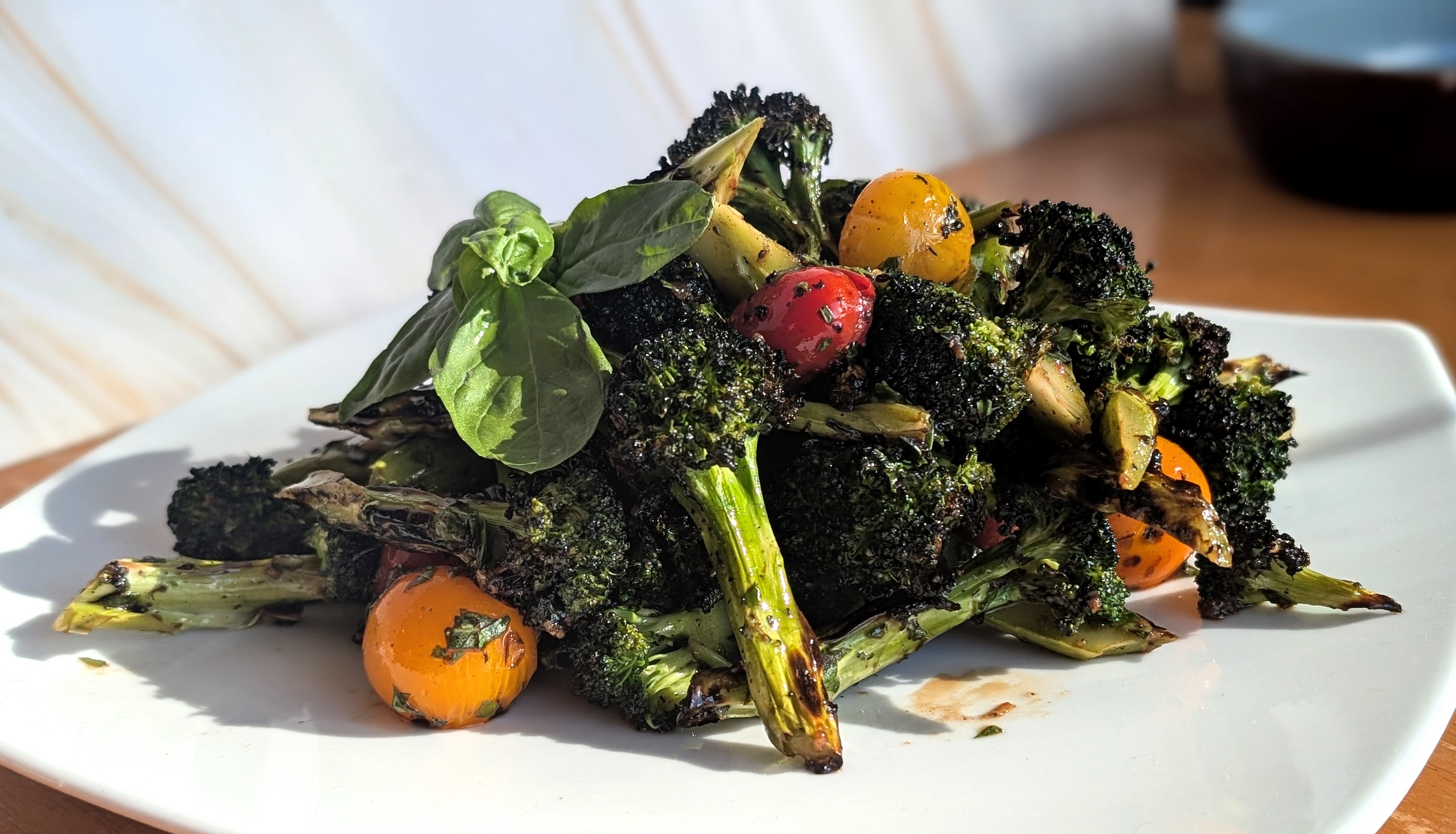 Charred broccoli with heirloom cherry tomatoes and fresh basil